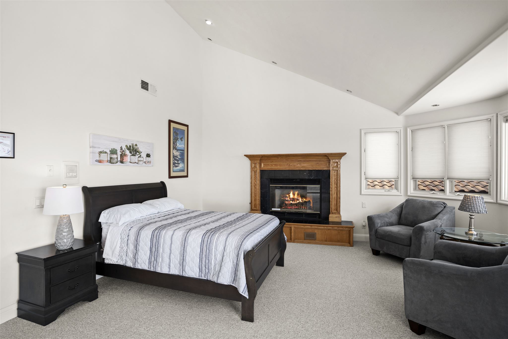 Private bedroom at Del Campo House with fireplace and armchairs