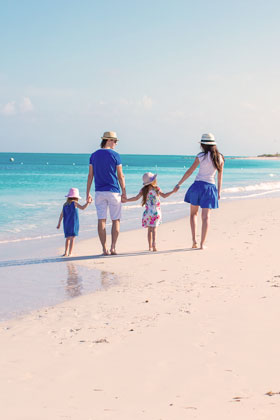 a family holding hands walking on the beach, family therapy