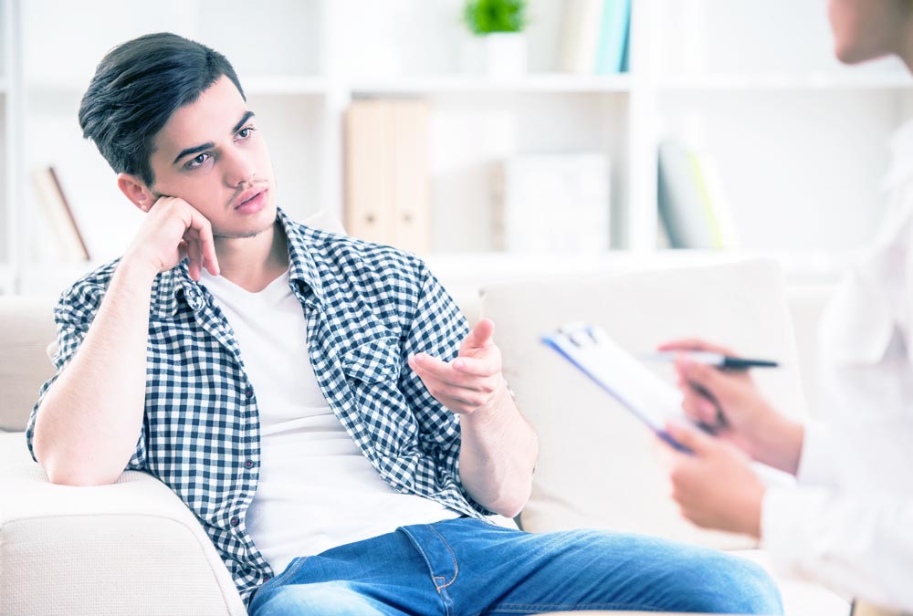 young man during one-on-one therapy session with a psychologist