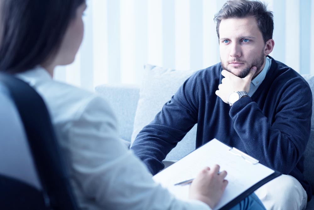 young man listening to his psychologist