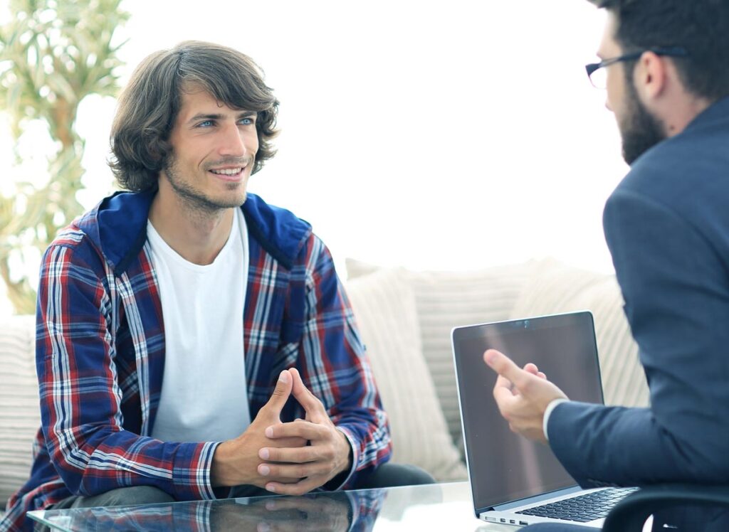 a medical staff discussing drug rehab options to a male client