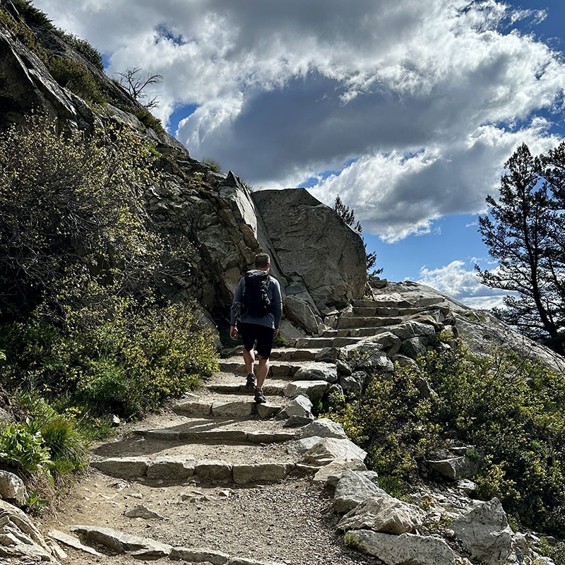 man hiking up stairs