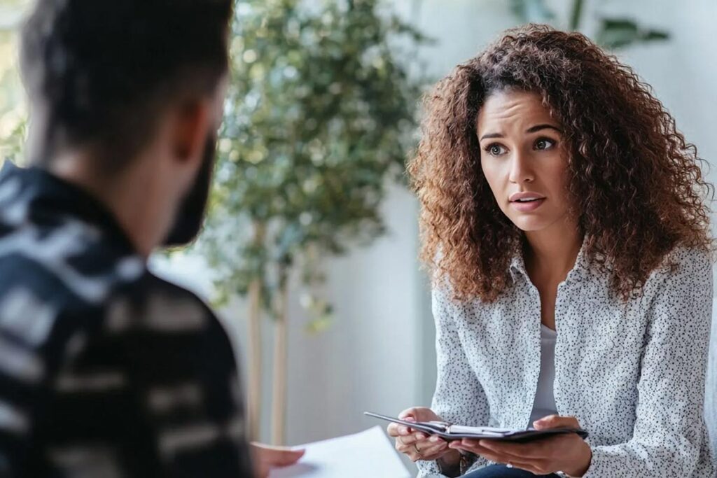 A licensed therapist talking to a client about symptoms of addiction in Orange County detox