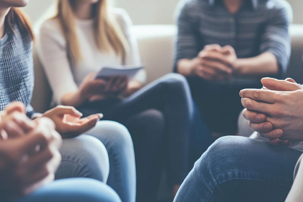 A support group holding pamphlets describing what to expect during the admissions process at Ocean Ridge