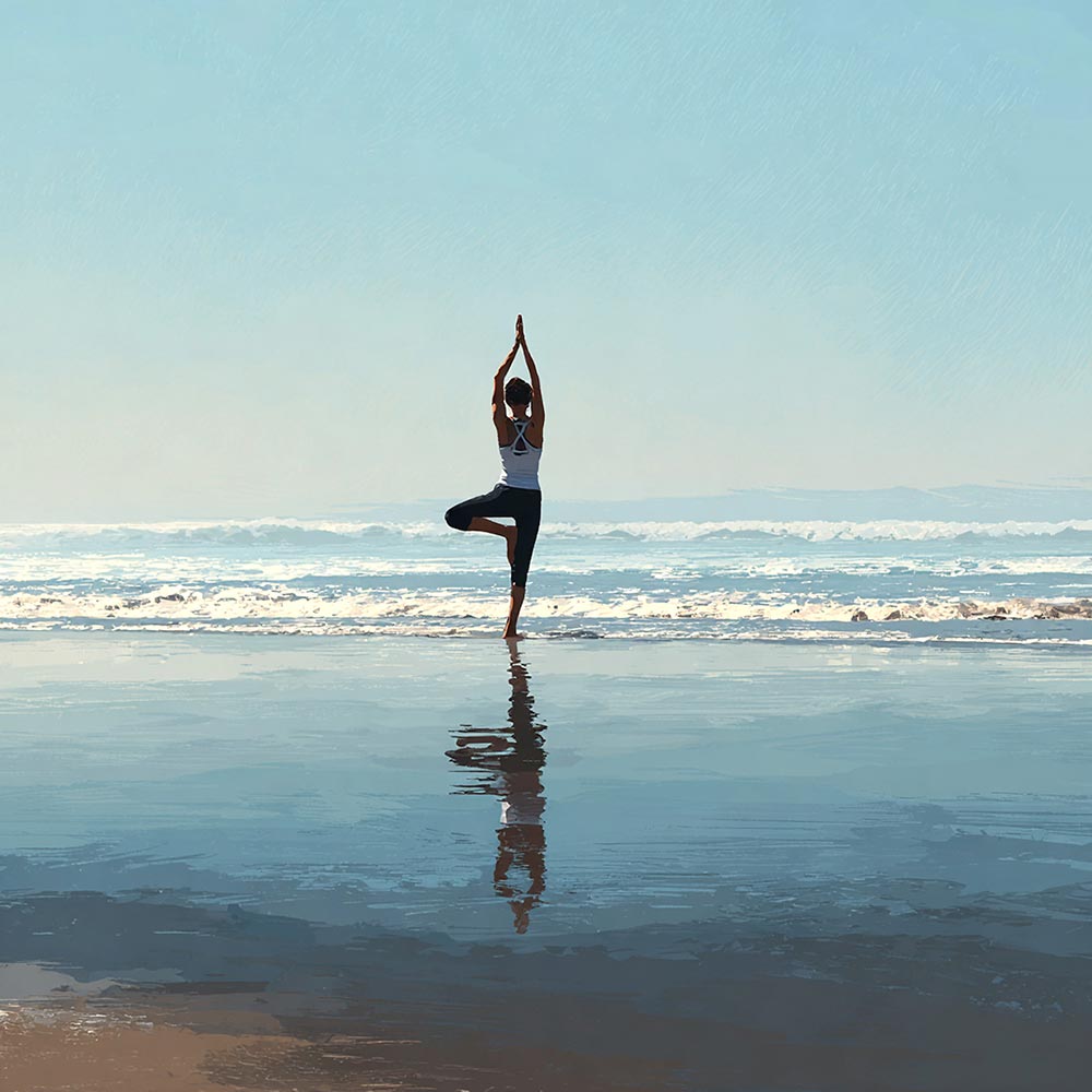 Woman doing yoga on the beach
