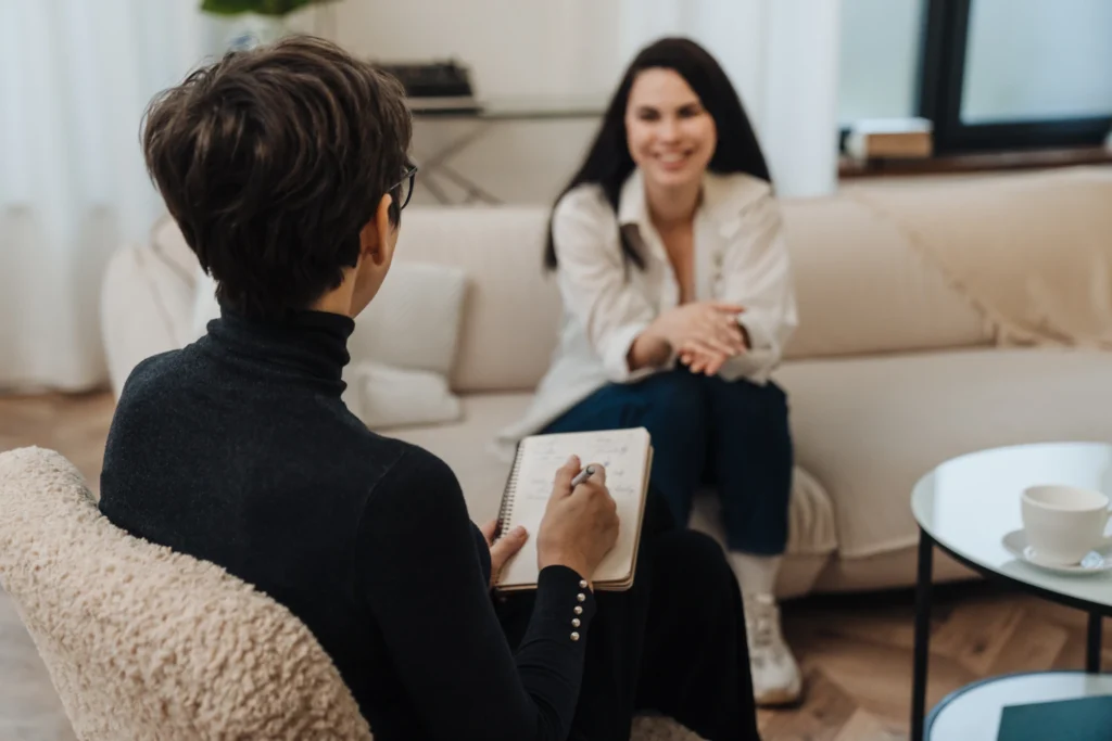 Professional receiving support for drug and alcohol recovery in a comfortable treatment setting.