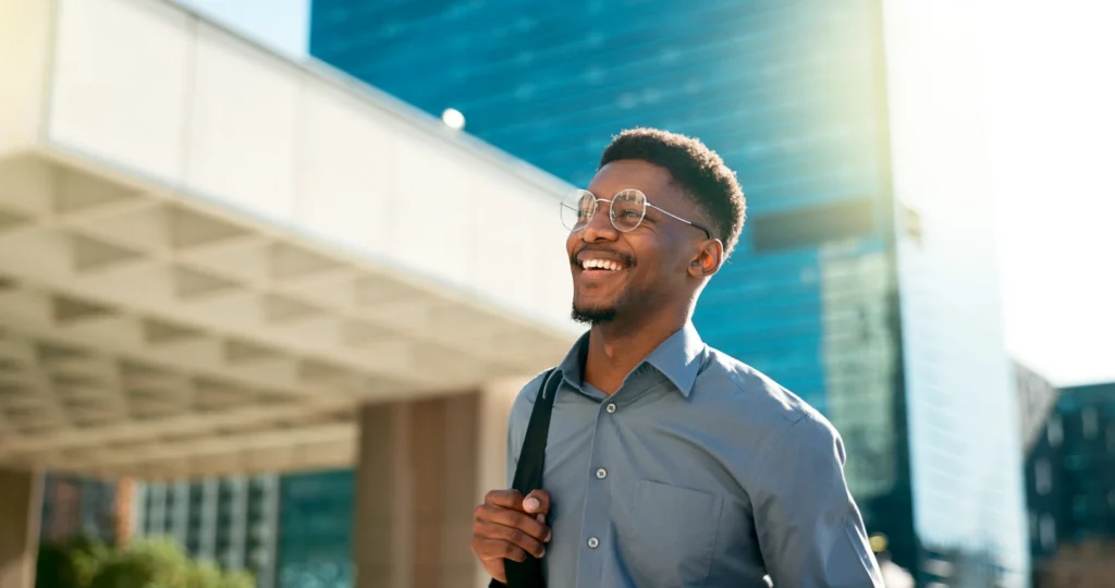 Smiling person in a calm outdoor setting.